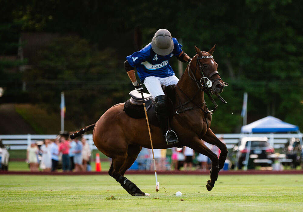 Aspetuck's Costi Caset taps the ball down the field.